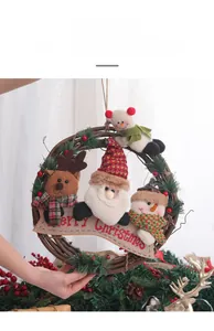 Detail of Christmas rattan wreath with plush Santa, Snowman, Reindeer and Merry Christmas sign