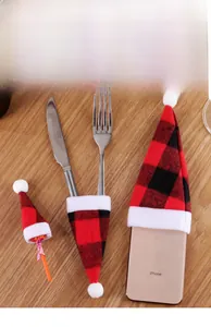 Detailed view of mini red plaid Christmas hats used for cutlery and holiday decor