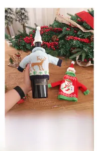 Detail of knitted Christmas wine bottle covers with snowman and reindeer patterns