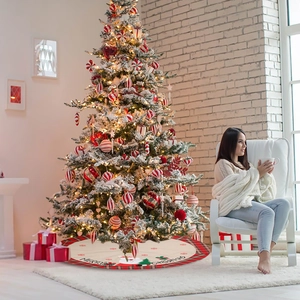 Red plaid Christmas tree skirt featuring Santa Claus motif and Merry Christmas print