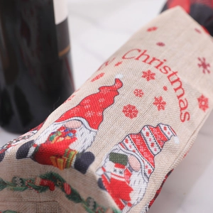 Christmas burlap wine bottle bag featuring red gnome and snowflake patterns for holiday decor
