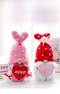 Close-up of knitted Valentine's Gnomes with heart decorations and pearl accents