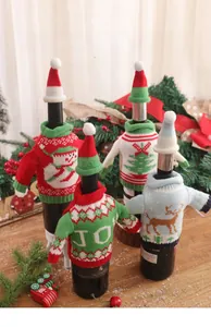 Detail of four festive knitted Christmas wine bottle covers with mini matching hats