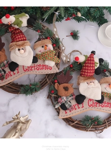 Macro shot of rustic Christmas rattan wreaths with Santa and Snowman plush decor