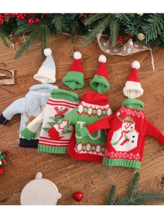 Detail of four festive knitted Christmas sweater wine bottle covers with various patterns