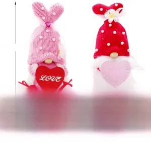 Macro view of knit Valentine's Day gnomes with heart and embroidered holiday greetings