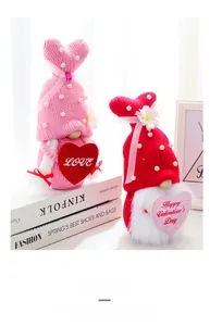 Close-up of knitted Valentine's Day gnomes with heart signs and pearl decorations