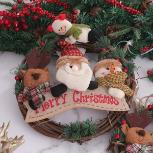 Festive Christmas rattan wreath featuring plush Santa, snowman, and reindeer ornaments