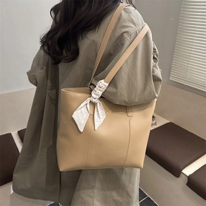 Large beige tote bag in premium faux leather with elegant silk scarf on shoulder strap