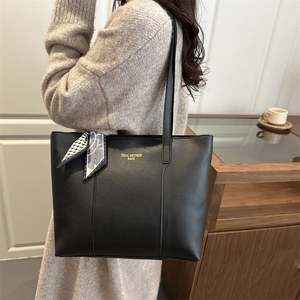 Classic black leather tote bag with silk scarf accent and long shoulder straps for women