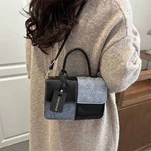 Contrast color patchwork crossbody bag with elegant handle and fashion tag for women