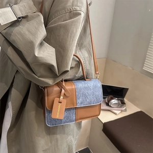 Women's color-block crossbody bag in brown leather and grey wool with fashion tag