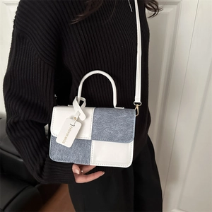 Blue and white checkerboard small square bag with contrast colors and long strap