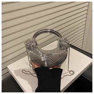 Silver metallic crescent clutch bag with radial texture and ring handle detail