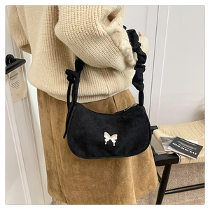 Detail of black crescent hobo bag with white butterfly motif and ruched shoulder strap