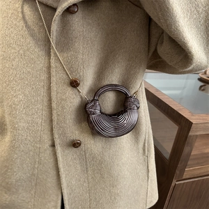 Chic brown crescent acrylic necklace with spiral texture and golden fine chain