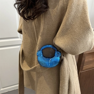Blue acrylic crescent bag with spiral texture, circular handle and gold chain strap