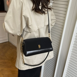 Classic black leather saddle bag for women with gold clasp and elegant chain strap details