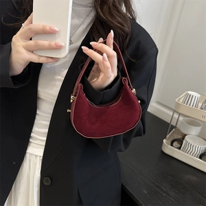 Mini crescent moon handbag in burgundy faux suede with adjustable metal buckle strap