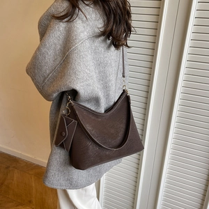 Deep brown pebble leather tote bag with white contrast stitching and a mini pouch attached