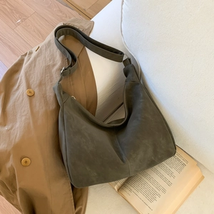 Detail of soft matte leather hobo bag with adjustable strap and natural drape
