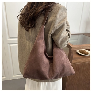Brown velvet hobo shoulder bag shown on model for a stylish oversized commuting look