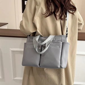 Large capacity grey nylon tote bag with multiple zipper pockets and adjustable strap