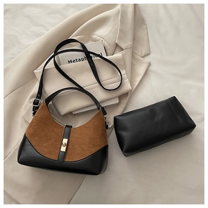 Close-up of contrast patchwork shell bag with gold buckle and matching clutch bag set