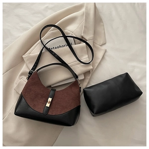 Detail of the two-piece shell bag set with contrast stitching and golden twist lock closure