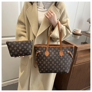 Macro detail of dark brown leather tote bag with vintage pattern and fine stitching