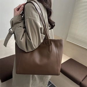 Minimalist deep brown faux leather tote bag with vertical structural stripes for women