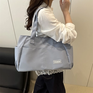 Large light blue nylon tote bag for women commuting, stylish casual shoulder handbag design
