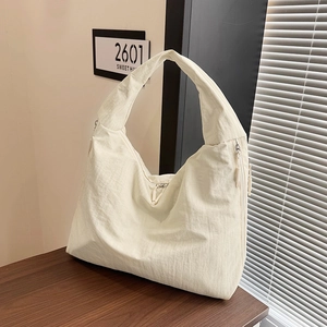 Detail view of the white large-capacity hobo bag featuring crinkled texture and zippers