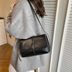 Retro black leather shoulder bag with vintage texture and gold buckle for women