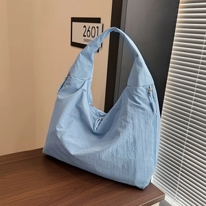 Light blue large capacity crescent canvas tote bag with zipper and pleated texture