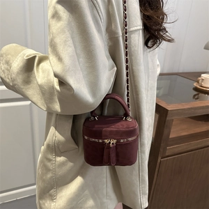 Burgundy suede mini cylinder crossbody bag with golden chain strap for women