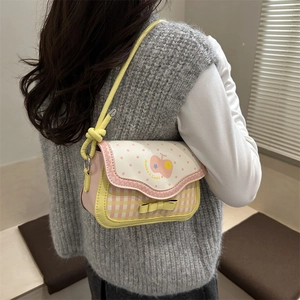 Pink apple-themed checkered crossbody bag with polka dots and yellow bow detail