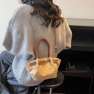 Vintage beige suede tote bag with brown leather handles and adjustable shoulder strap