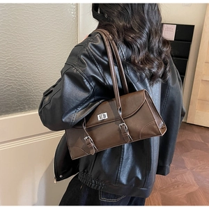 Detailed view of dark brown vintage shoulder bag with silver buckle and sleek texture