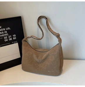 Detail of vintage brown tote bag texture and adjustable wide shoulder strap with metal buckle