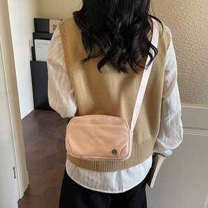 Pink nylon crossbody bag for women with lightweight water resistant fabric and metal logo