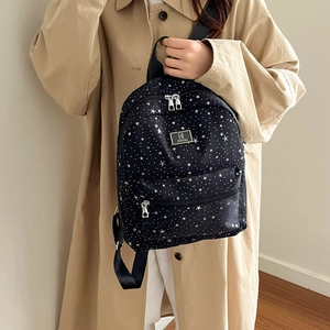 Black school backpack with white star pattern and large capacity for students