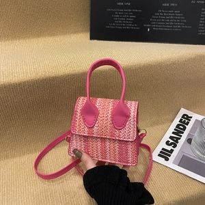 Ethnic woven mini handbag with pink leather handle and gradient color stripe design