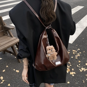 Brown patent leather hobo bag for women with cute bear charm and silver hardware