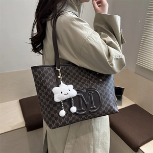 Fashionable brown tote bag with M-letter print and white cloud charm accessory