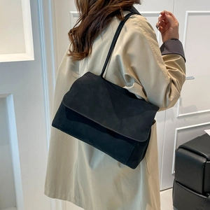 Minimalist black suede shoulder bag for women with a sleek rectangular flap design