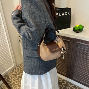 Retro light brown suede hobo bag with dark leather handle and stylish beaded pendant