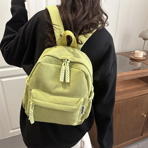 Minimalist light green corduroy mini backpack with woven zipper and fashion label