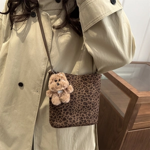 Retro leopard print bucket bag for women with a plush dog charm and brown leather strap
