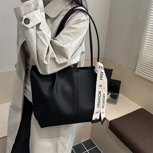 Classic black tote bag in matte synthetic leather with stylish ribbon detail for women